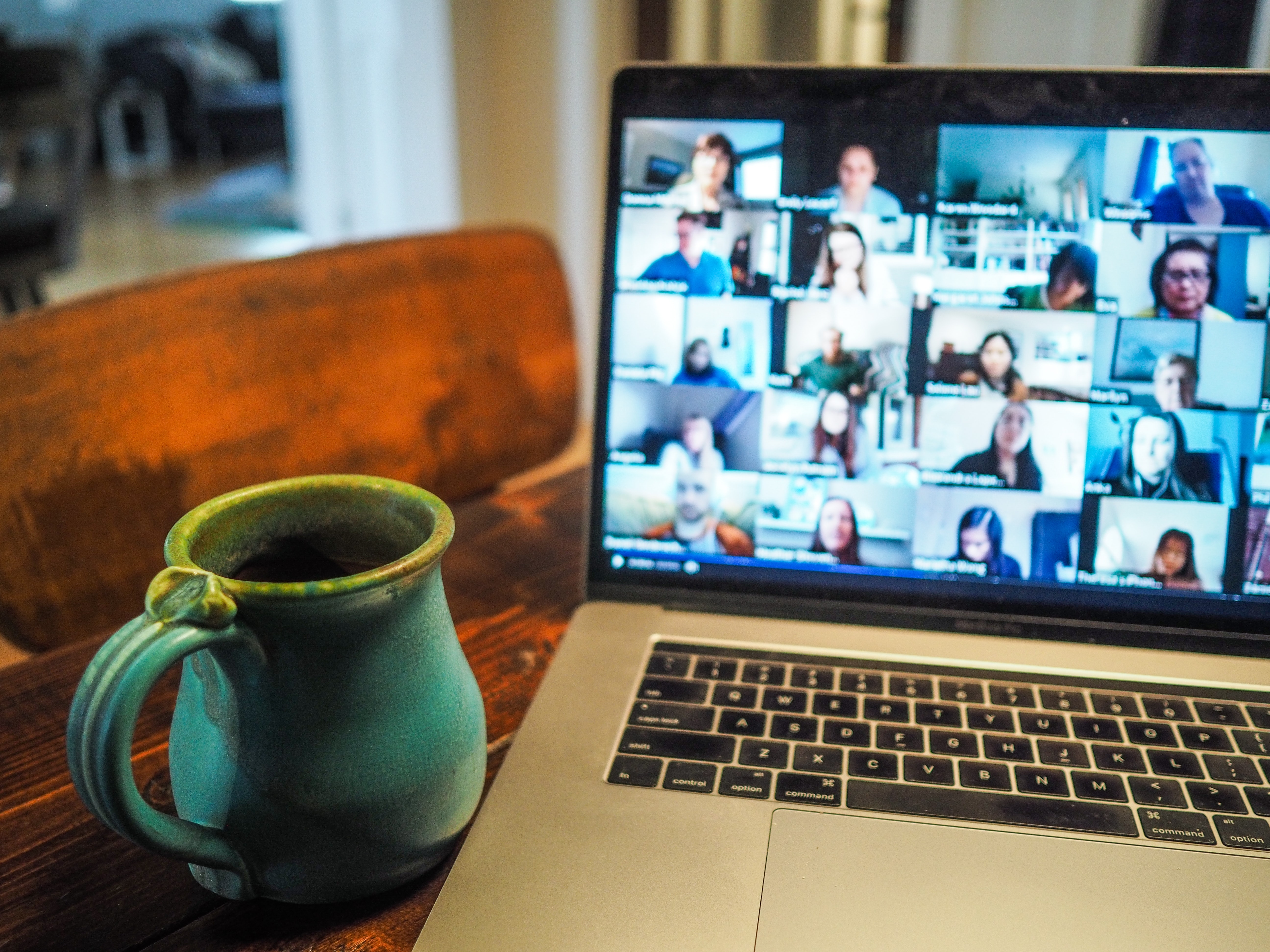 laptop with zoom meeting and coffee mug