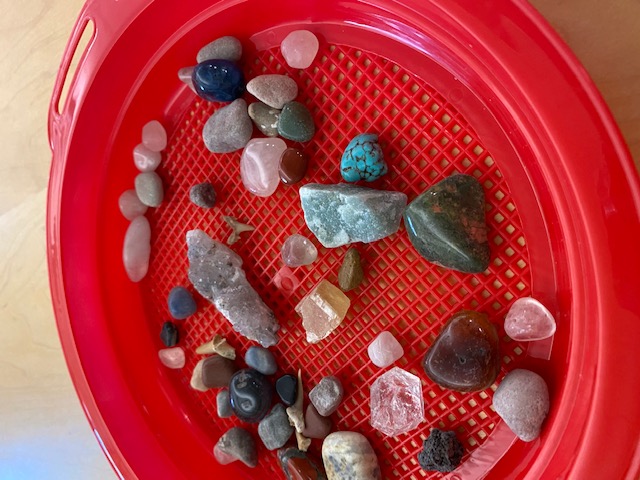 assorted minerals and gems in a sand sifter