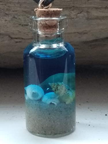 shells, sand and blue water in a mini glass bottle.