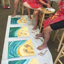 painting the beach with feet