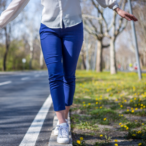 woman walking along edge of road