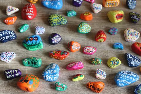 rocks painted with kind words such as love, kindness, hope