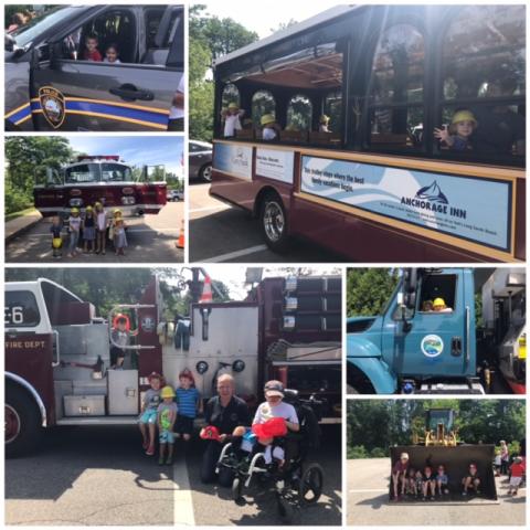 fire truck, police car and public works truck with children