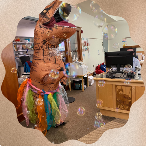 dinosaur in a tutu surrounded by bubbles