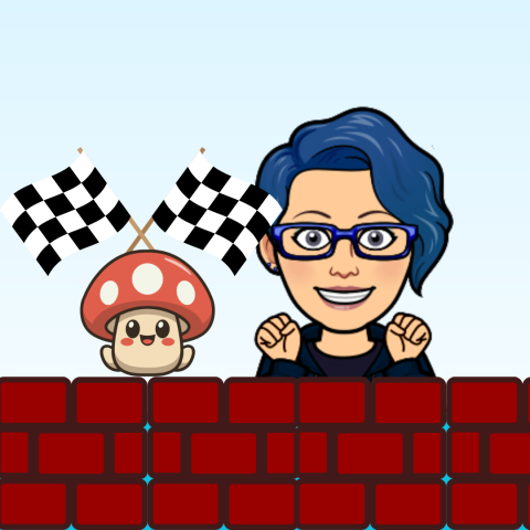 Danie standing behind a brick wall next to a Mario Kart mushroom waving racing flags