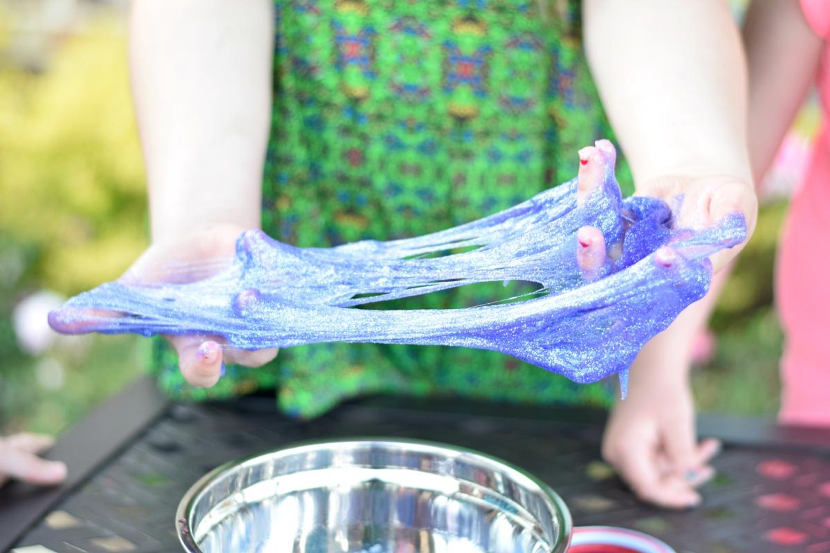 hands playing with slime