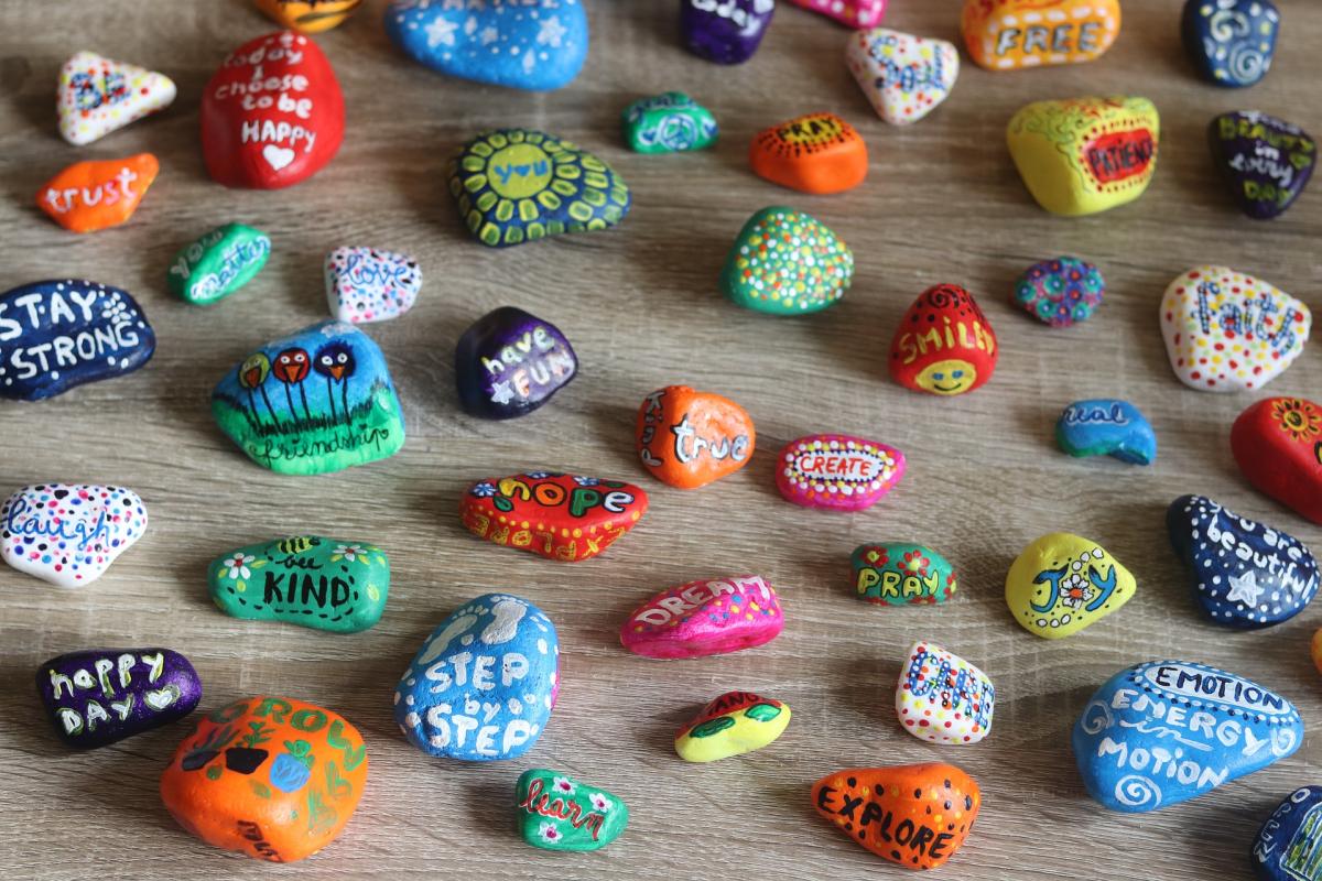 rocks painted with kind words such as love, kindness, hope