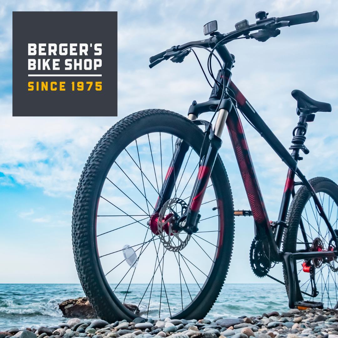 bike at the beach with logo for Berger's Bike shop in the corner of the photo